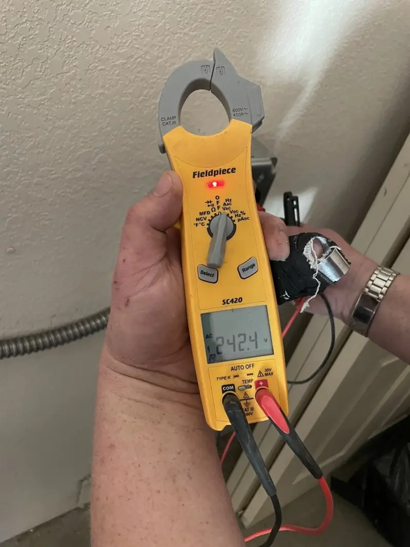 Voltage testing with clamp meter during Generator Installation in Petoskey